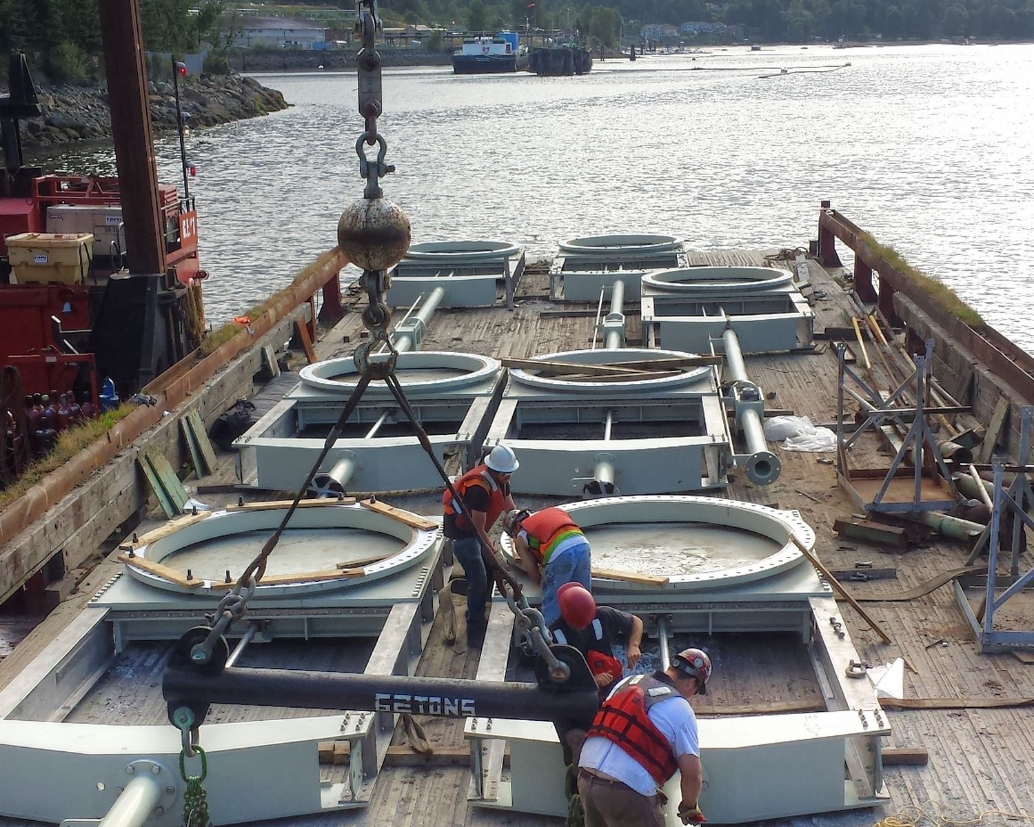 Crew preparing gate components on the barge
