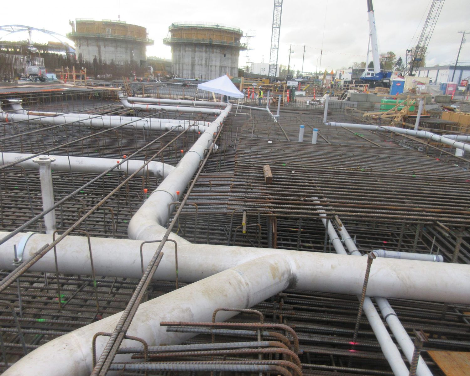 Large-bore stainless piping over rebar mats