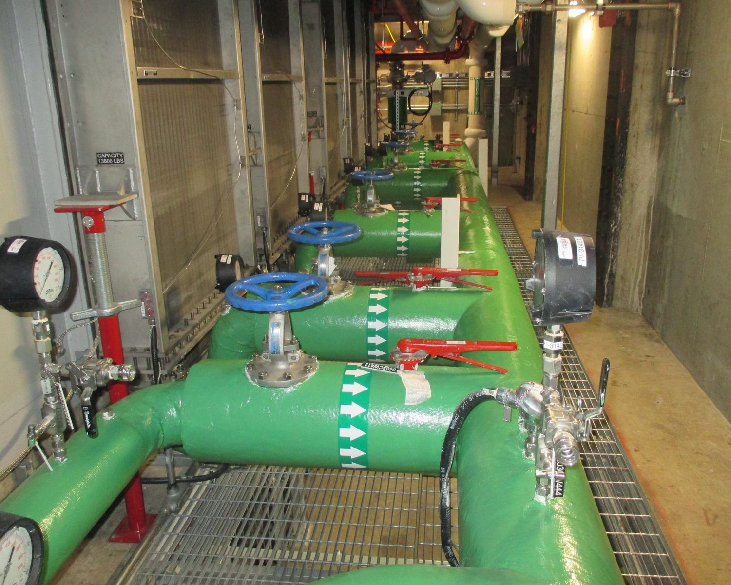 New green piping with valves in the powerhouse gallery