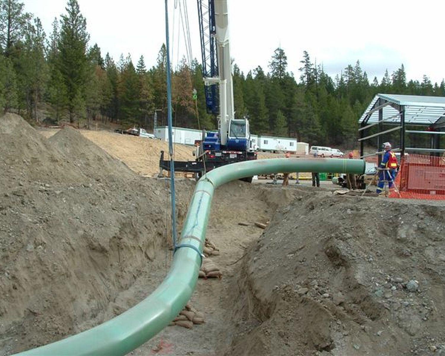 Coated piping entering a trench